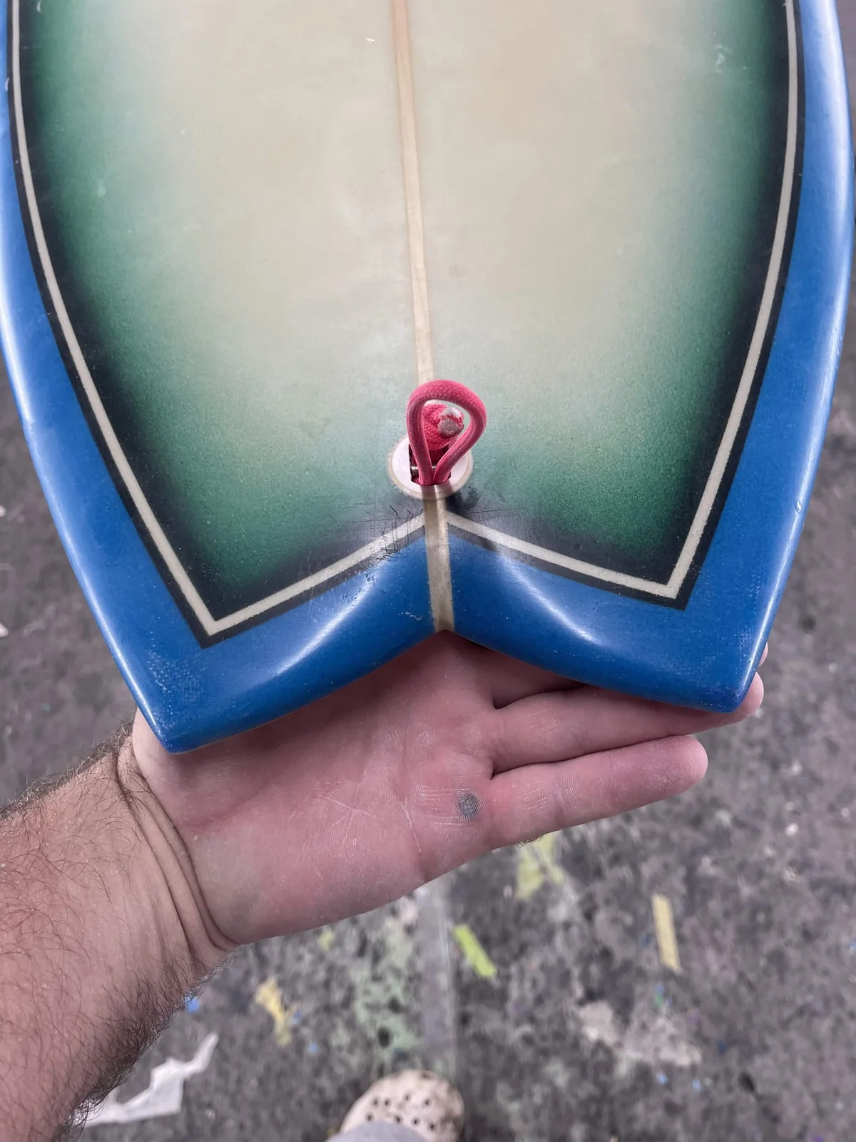 Finished blue and green fishtail surfboard tail