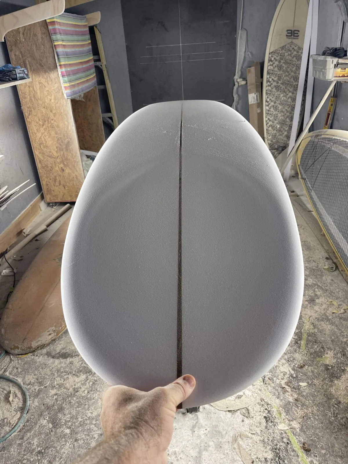 Close view of a rounded surfboard nose shaped from foam